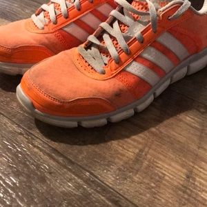 Orange Adidas running shoes